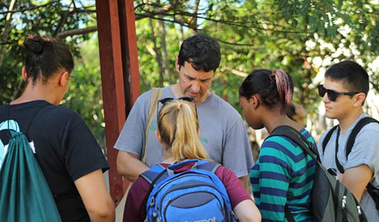 Marcelo tutoring students from Oswego New York State University in the use of GPS (Global Positioning System) to record features during a Projeto Puma expedition in the Brazilian Amazons.
