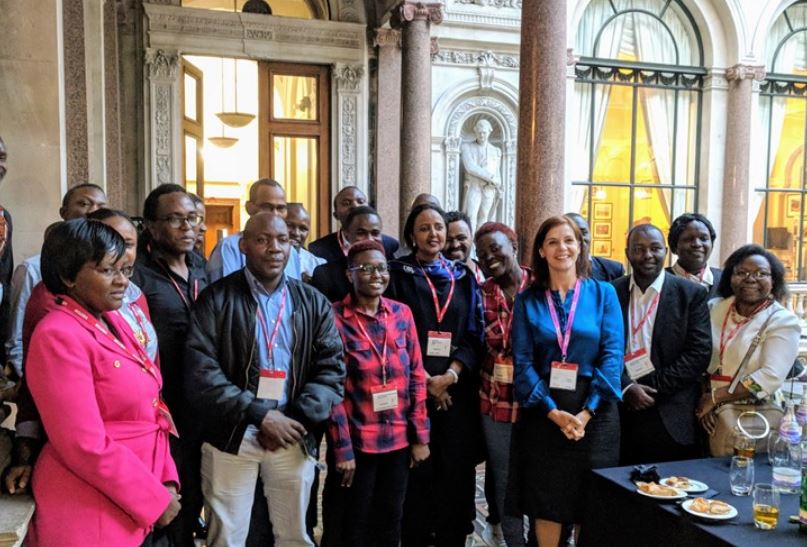 Scholars interact with Joanna Roper and Amina Mohamed at the FCO