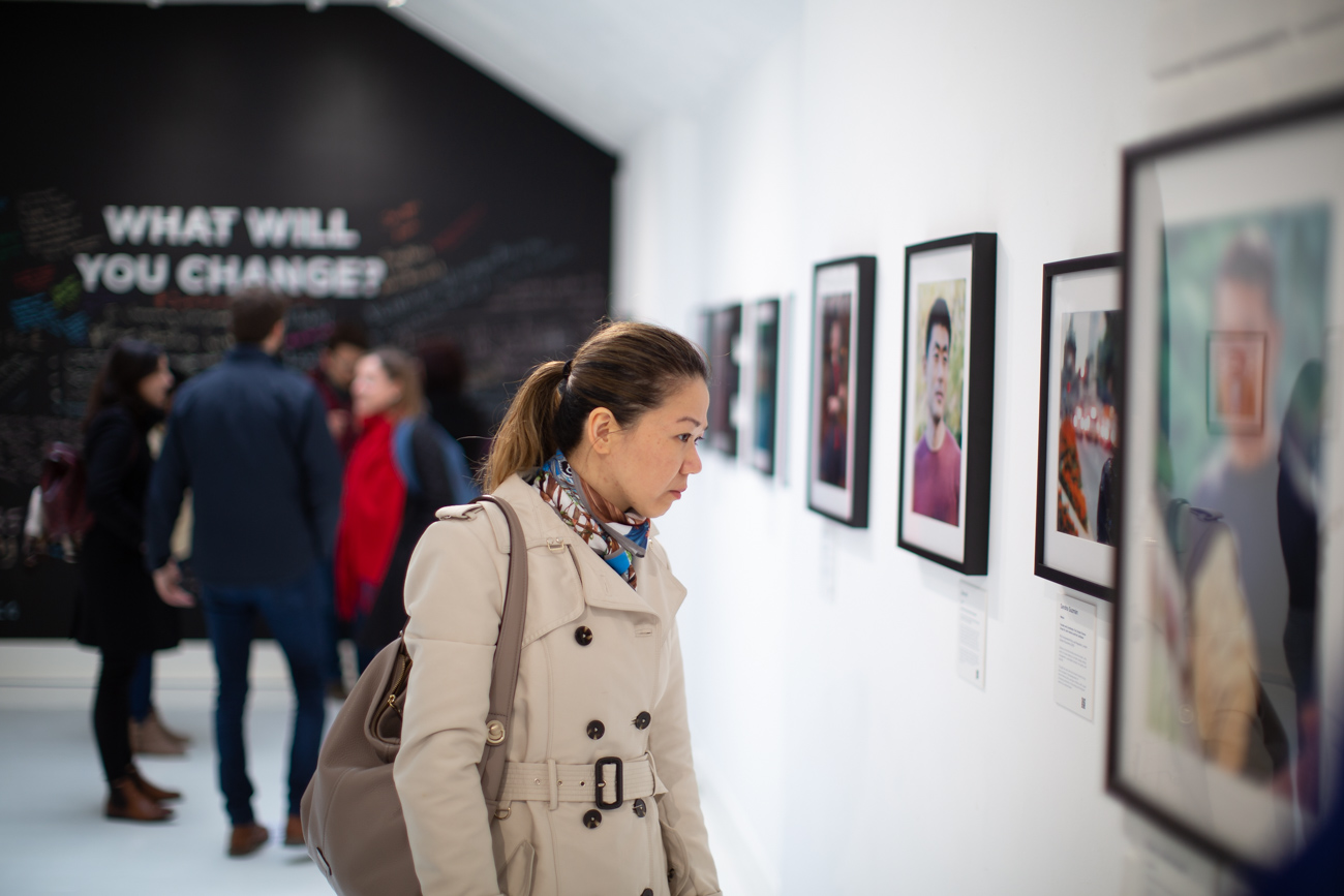 A Chevening Alumna surrounded by other great Cheveners at a photography exhibition in London