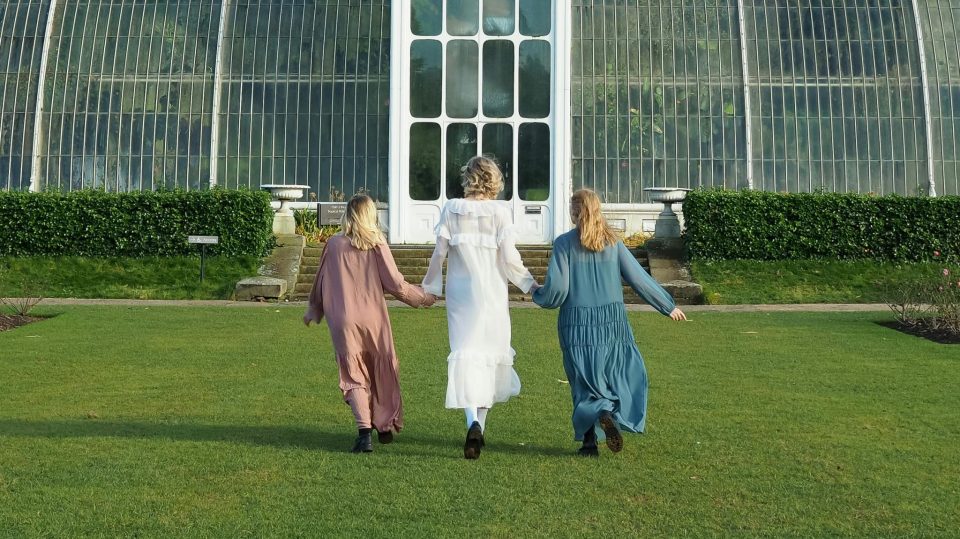 women walking towards a greenhouse