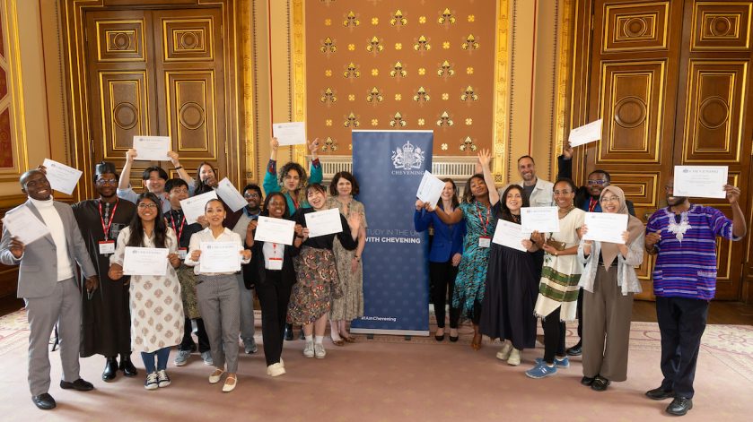 A group of people holding certificates and smiling