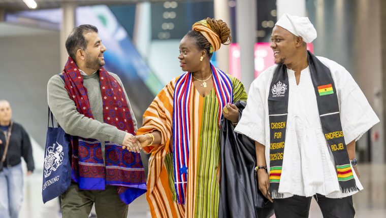 A group of people smiling and shaking hands