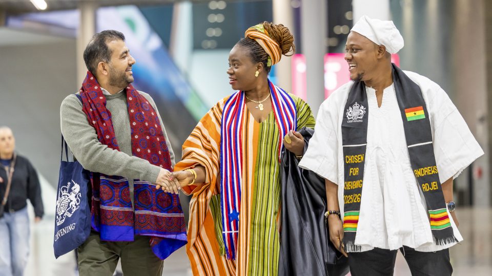 A group of people smiling and shaking hands